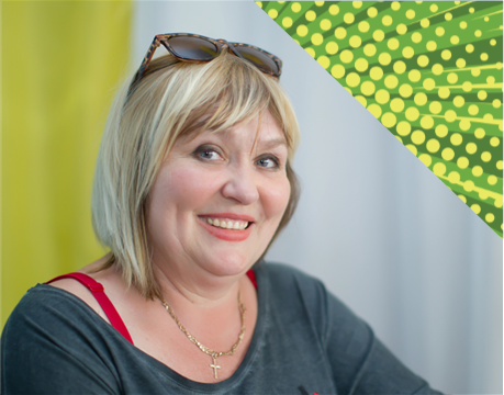 smiling blonde woman with sunglasses on her head