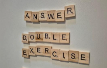 'answer double exercise' spelt out in wooden tiles on the wall