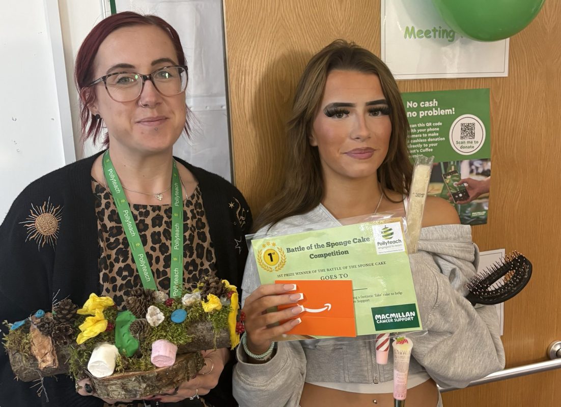 A woman to the left with red hair holding a cake and a girl to the right holding her first place certificate